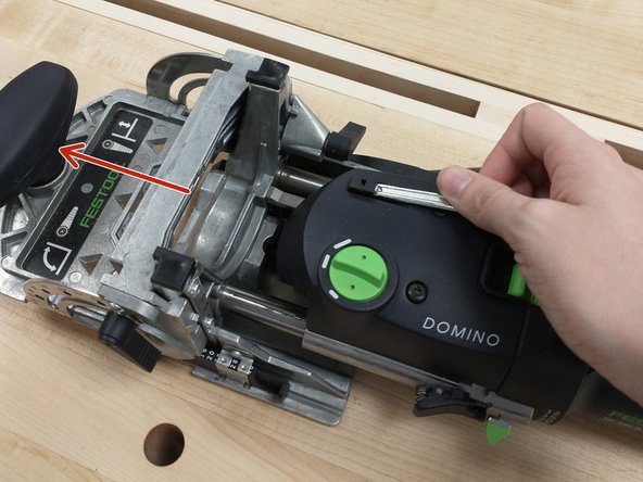 Use one of the provided wrenches to pop the button out, then pull the head off of the machine.
