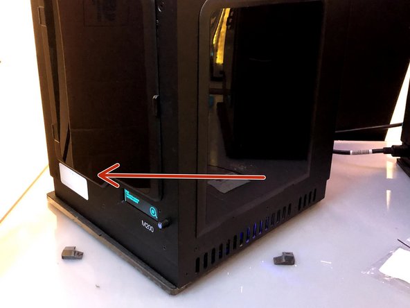 Rotate the printer to the left to access the rear, where the printer spool is