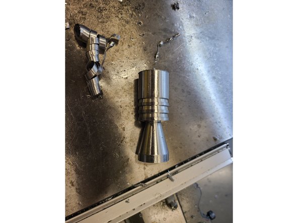 Checkpoint 4: Parting the stage from the stock and turning down the taper (Pictures 1 and 2). This step requires the face milling tool and the parting tool.