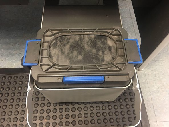 Verify that the Powder Bin is completely closed. If the bin is slightly open, powder may leak out during the next step