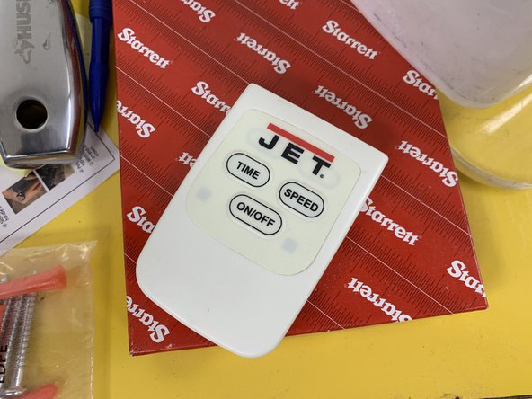 Locate remote on the top of the yellow chemical cabinet.