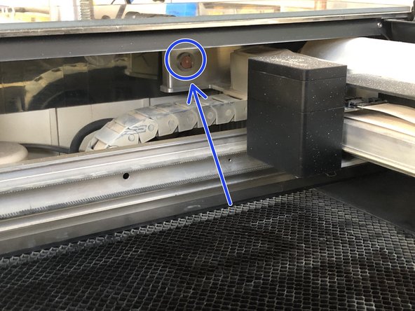 Carefully reach over the left rail and wipe the window on the left side of the housing using a Zeiss wipe
