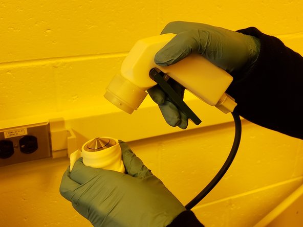 Use the nitrogen gun to blow the resist/oil off of the lens.