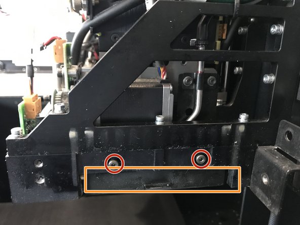 Unscrew the two screws circled using the smallest allen wrench