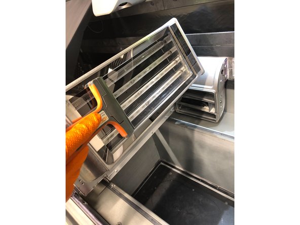 Use a glass scraper with a metal razor to scrape any fused material from the fusing lamp glass.