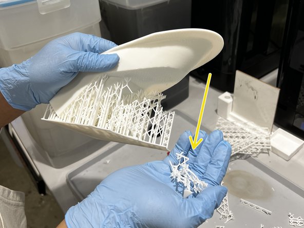 Once all accessible support structures are severed from the model, begin cutting away larger chunks of support.