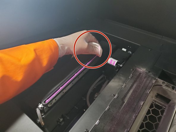 With a lint-free cloth and DI water, clean the print head cap (on the left) gently