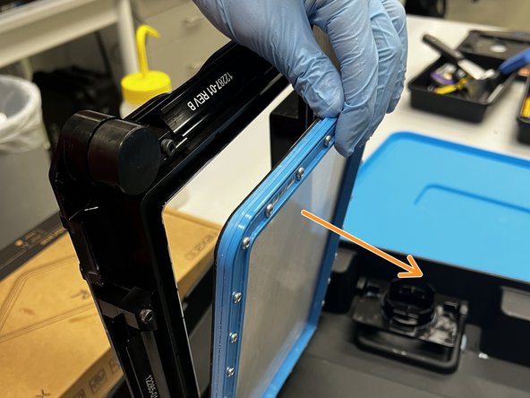 Turn the tank upside-down. Undo each of the four latches on each side of the membrane.