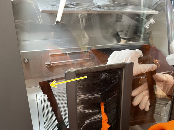 Release the pins on both sides of the build box