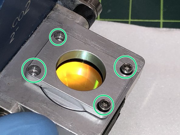 Gently tighten the four screws that hold the holder in place