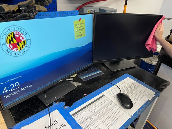 Use paper towels to wipe down the monitors and table