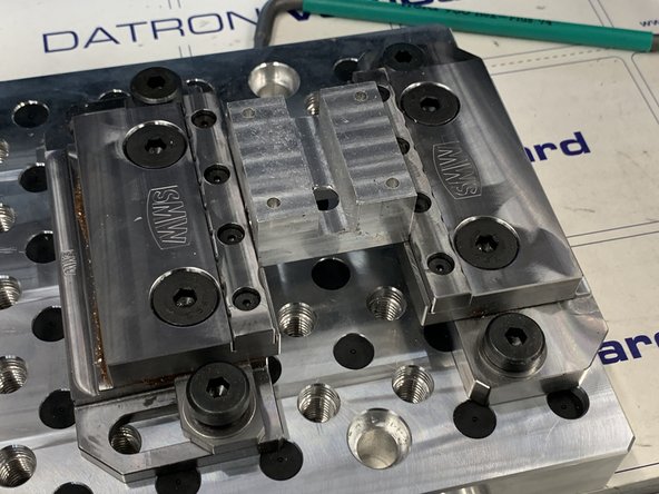 Loosen both moving vise mounting bolts and both clamping bolts.