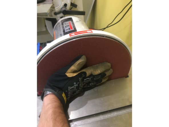 Carefully slide the pad between the disc and the plate, with the adhesive side toward the disk. Make sure that no debris comes in contact with the adhesive, as this will cause the pad to adhere improperly.