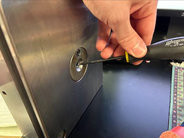 Solution: Remove the plate from the machine. Using a smaller sized allen key, hammer the sprue through so that the part comes out. Apply mold release to  the mud plate side and spread with a paper towel.