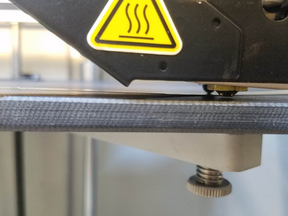 Adjust the thumbscrew until you feel slight resistance on the shim and press Next