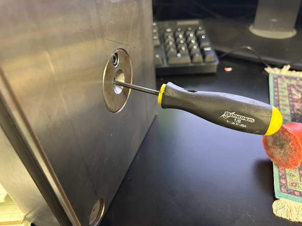 Solution: Remove the plate from the machine. Using a smaller sized allen key, hammer the sprue through so that the part comes out. Apply mold release to  the mud plate side and spread with a paper towel.