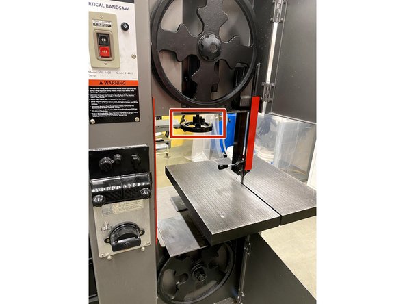 Use this black knob to loosen the blade in the bandsaw.