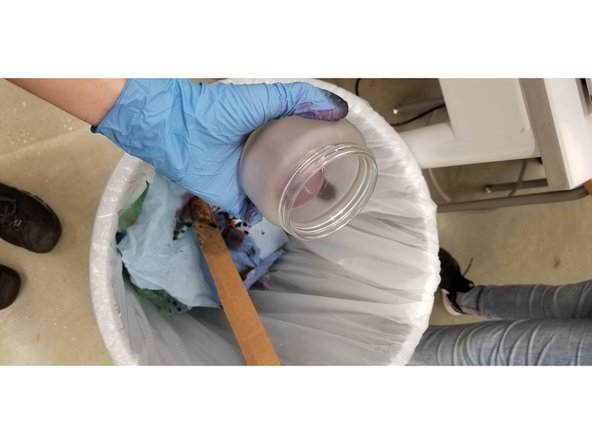 Empty waste container into the trash can. Wipe down the inside of the glass container with paper towels to remove excess paint and cleaners.