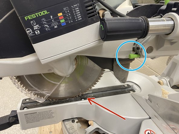 Using the bottom trigger, lower the saw all the way into the saw well.