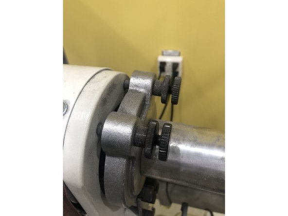 Loosen the lock nuts (Part A) then begin to turn the front screw (Part B) while turning the belt by hand.