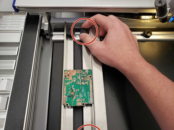 Move the manipulator out of the way and unscrew the right lath to release the board.