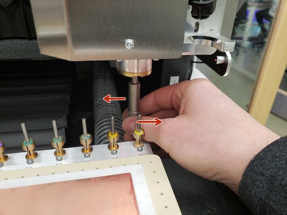 Push the collet back into the spindle and twist clockwise to lock it back in place