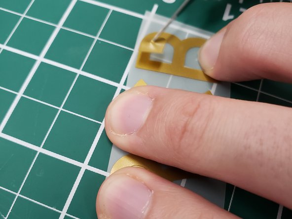 Use a razer blade to remove and fine or small piece of vinyl that you don't want to be in the final sticker