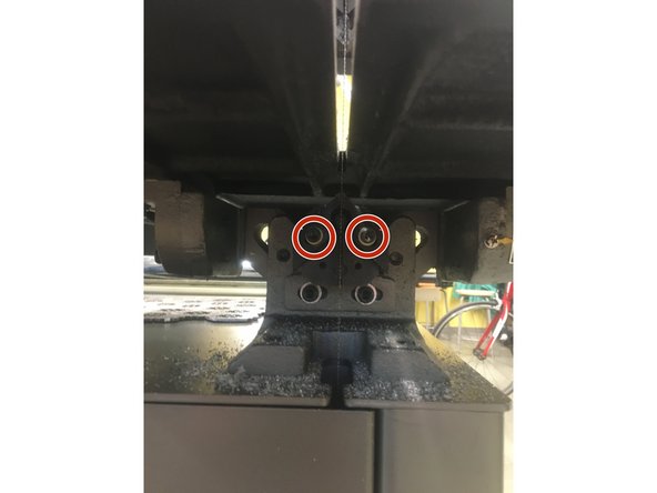 Next, insert the new blade. To do this, you may need to loosen the blade guides above and below the bed. Use a 5mm hex key to loosen the bolts.