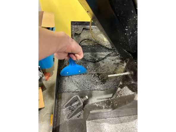 Use a brush to sweep and collect the chips in a pile.