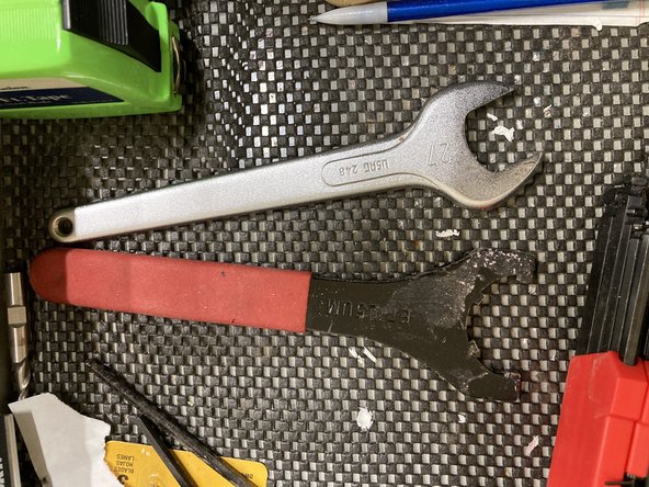 Using the two wrenches in the top drawer of the desk, loosen the collar of the spindle to access the collet and tool. Once desired tool and collet are in place, screw the collar back onto the spindle and tighten firmly