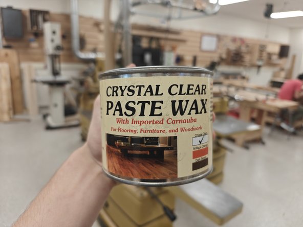 Grab the Crystal Clear Paste Wax from atop the chemical cabinet, as well as a Popsicle Stick and either a white rag or a cut up tee shirt