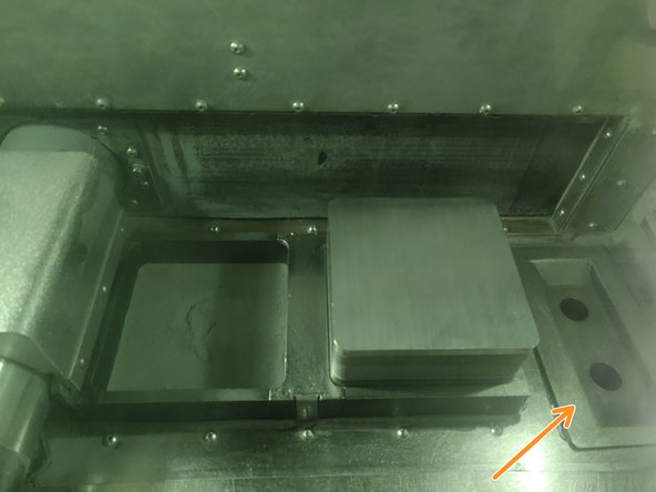 Using the gloves inside the ProX chamber, slowly add powder to the powder bed. After each 1/4 canister, use the bottom of the canister to tamp powder down. Make sure to keep this level and compact,  tamping powder throughout the loading process.