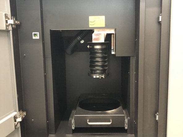 Open the center utility cabinet door