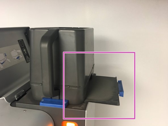 After the majority of the powder has fallen into the hopper, you may tap the sides of the Powder Bin, and tilt the Bin very slightly to allow powder trapped in the corners to fall into the Hopper
