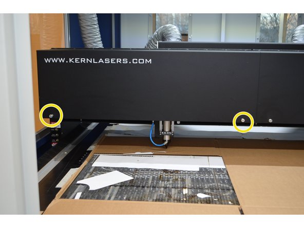 Open the shroud on the X-axis gantry by unscrewing the thumbscrews