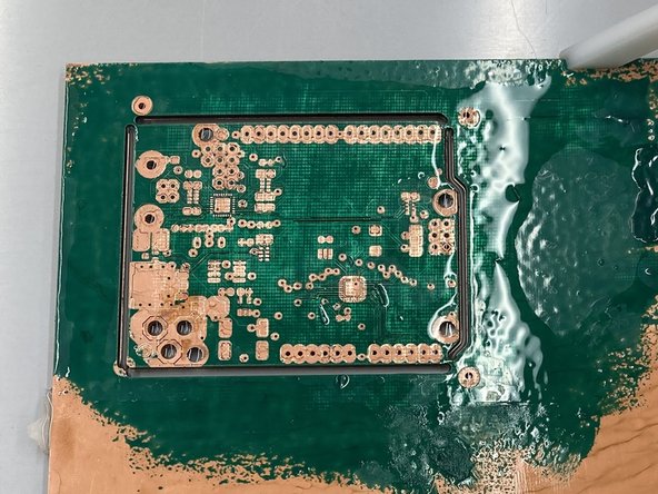 Pour the solution into the bin provided with the kit and scrub off the uncured solder mask/silkscreen with the paintbrush