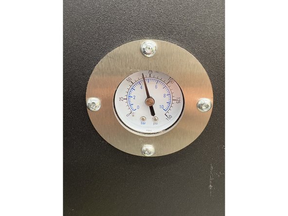 Make sure the light is still turned on. Find the pressure knob discussed earlier. Pull the knob out to enable twisting. Twist the knob till the pressure dial reads 60-70psi. Push the knob back in to lock the pressure.