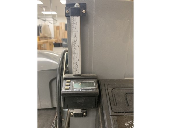 Adjust the locking arm to the vertical position to make gross adjustments.