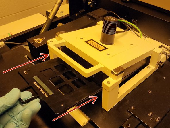 The tape and slide should be facing downwards.