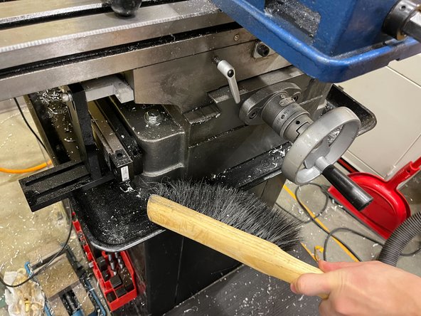 Use a brush to clean underneath the table