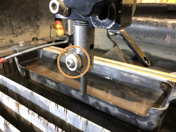 Unscrew bolt and *while holding the nozzle* pull it out from the sprayer.