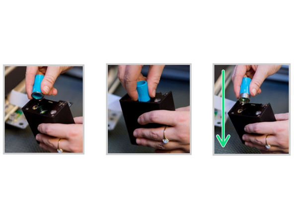 Gently insert the lens tool (found on the right side exterior of the GF) into bottom of the head with the &quot;Remove&quot; arrow pointing in. When you hear the magnet click, withdraw the tool and the lens.