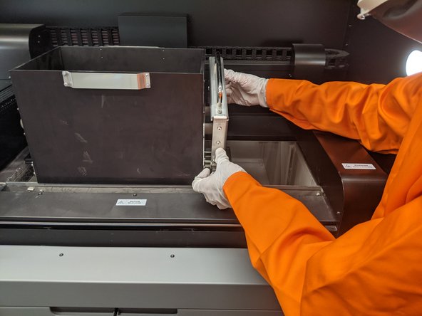 Once the build cake is fully pushed up, the printer will prompt the operator to push in the engagement pins