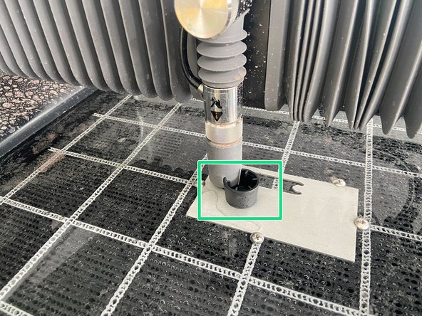 Place the flange of the cap under the nozzle, then adjust the nozzle height so the nozzle rests on the flange