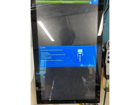 while holding onto the tool, select ok on the screen. the tool should secure itself after selecting ok.