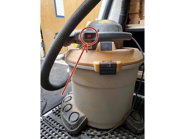 The power button is shown by the red circle, make sure it is plugged into a wall outlet first.