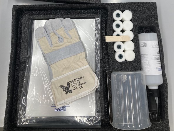 The other contains tips for the roller, gloves, a beaker, and a bottle