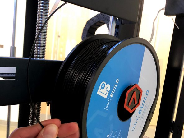 Place the new spool on the machine so that the filament unspools on the side nearest to you