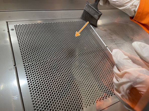 Pour the contents of the waste jar through the handheld sieve while holding it above the hopper