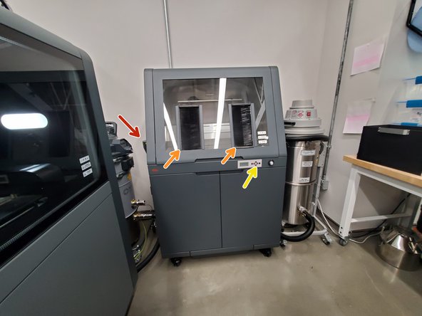 There is a cyclone separator on the side of the powder station, with a fines jar and vacuum inlet